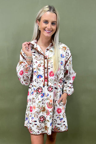 Woman wearing a floral dress against a green background