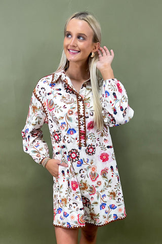 Woman wearing a floral dress against a green background