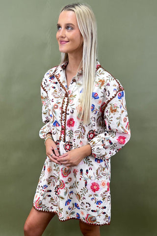 Woman wearing a floral dress against a green background