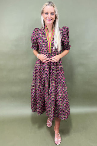 Woman wearing a floral dress against a green background