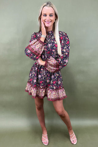 Woman wearing a floral dress against a green background