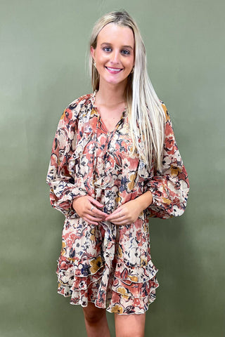 Woman wearing a floral dress against a green background