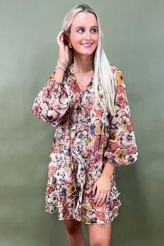 Woman wearing a floral dress against a green background