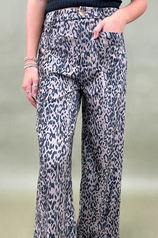 Leopard print pants worn by a person on a plain background