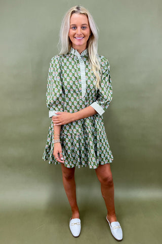 Woman wearing a black and white outfit against a blue background
