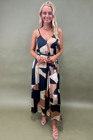 Woman wearing a patterned dress against a plain background