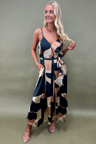 Woman wearing a patterned dress against a plain background