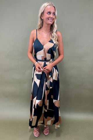 Woman wearing a patterned dress against a plain background