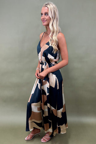 Woman wearing a patterned dress against a plain background