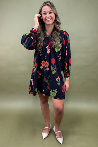 Woman wearing a floral dress against a green background