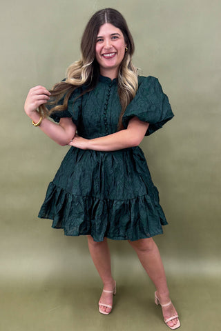Woman wearing a green dress against a green background