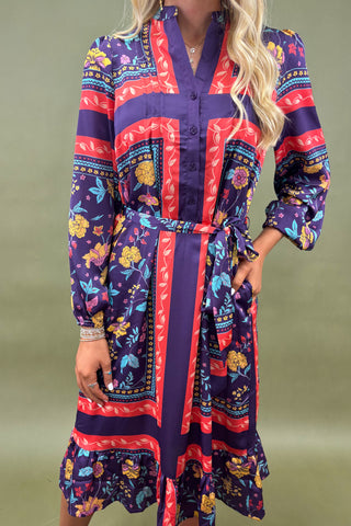 Colorful patterned dress worn by a person on a green background