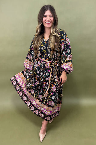 Woman wearing a floral dress against a green background