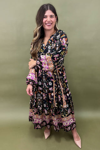 Woman wearing a floral dress against a green background