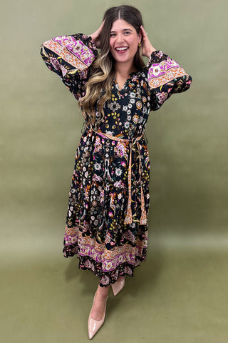 Woman wearing a floral dress against a green background