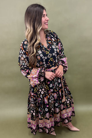 Woman wearing a floral dress with a green background
