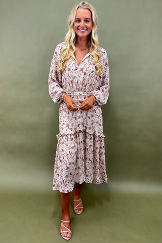Woman wearing a floral dress against a green background