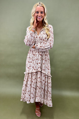 Woman wearing a floral dress against a green background