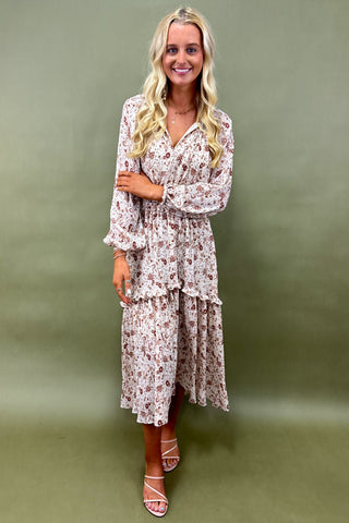 Woman wearing a floral dress against a green background