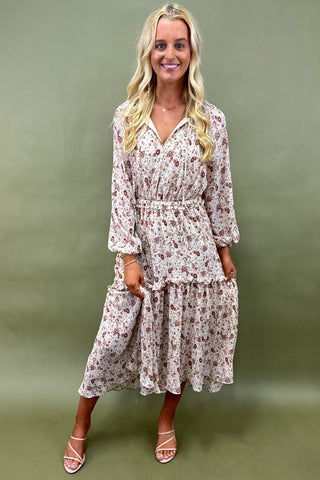 Woman wearing a floral dress against an olive green background