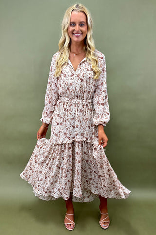 Woman wearing a floral dress against a green background