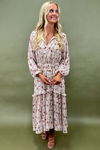 Woman wearing a floral dress against a green background