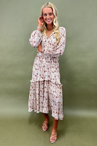 Woman wearing a floral dress against a green background