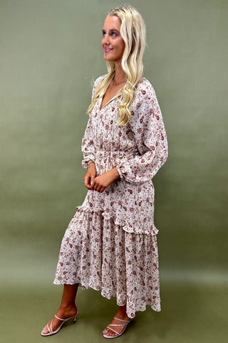 Woman wearing a floral dress against a green background