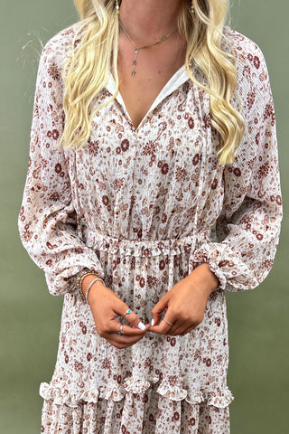 Woman wearing a floral dress with a plain background