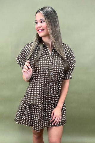 Woman wearing a polka dot dress against a green background