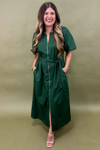 Woman wearing a green dress against a matching background