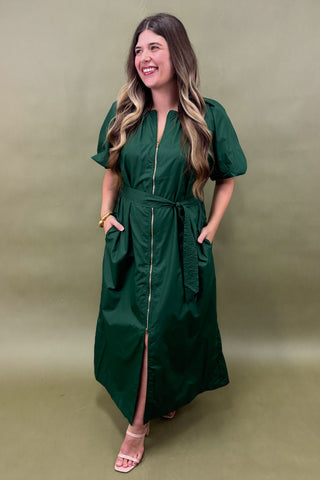 Woman wearing a green dress against a matching background