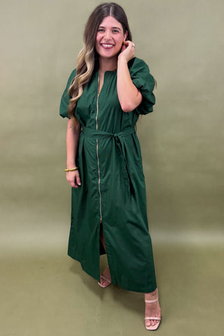 Woman wearing a green dress against a green background