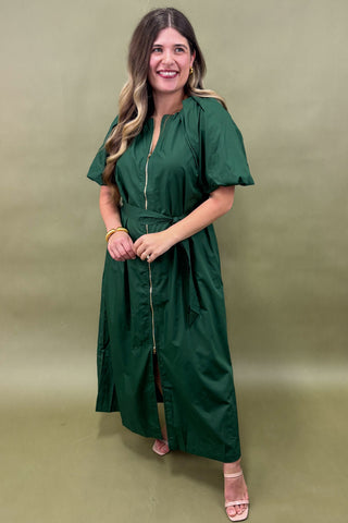 Woman wearing a green dress against a green background