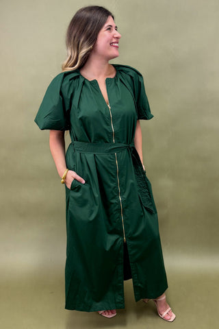 Woman wearing a green dress against a green background
