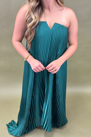 Teal strapless dress worn by a person on a beige background