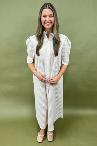 Woman wearing a white checkered dress against a green background