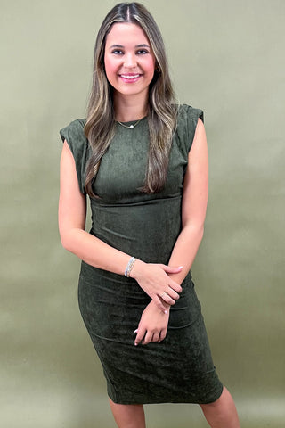 Woman wearing a green dress against a green background