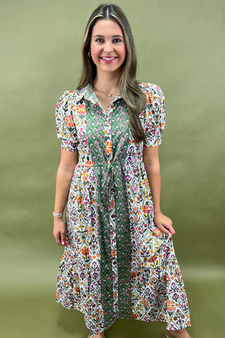 Woman wearing a floral dress against a green background