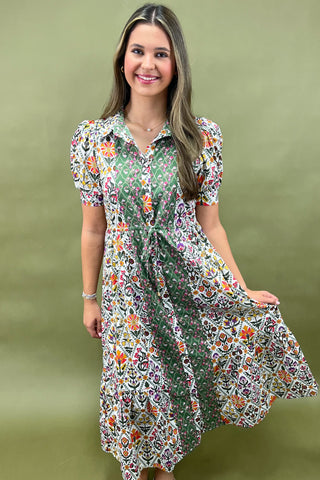 Woman wearing a floral dress against a green background