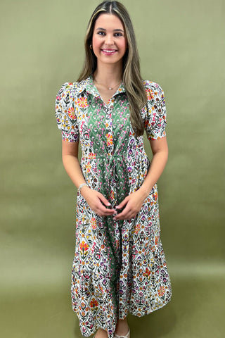 Woman wearing a floral dress against a green background