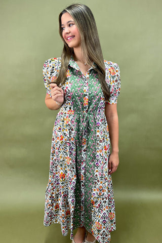 Woman wearing a floral dress against a green background