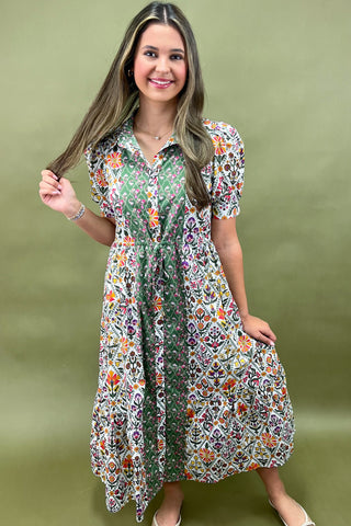 Woman wearing a floral dress against a green background