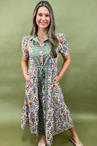 Woman wearing a floral dress against a green background
