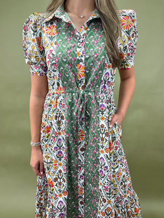Woman wearing a floral dress with a green background