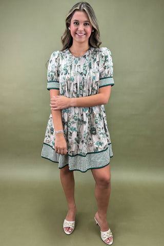 Woman wearing a floral dress against a green background