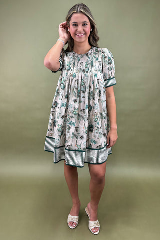 Woman wearing a floral dress with a green background