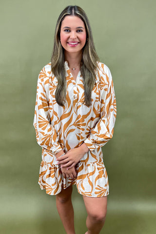 Woman wearing a patterned outfit against a green background
