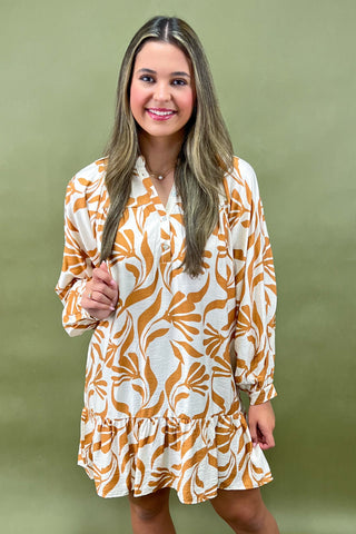 Woman wearing a floral dress against a green background