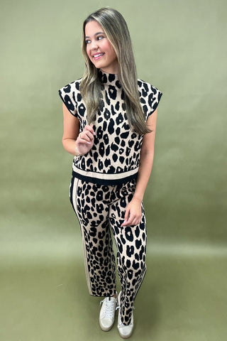 Woman wearing a leopard print outfit on a green background